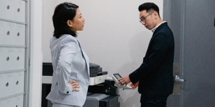Woman and man with printer in office